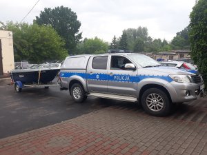 radiowóz wyjażdżający z łodzia motorową