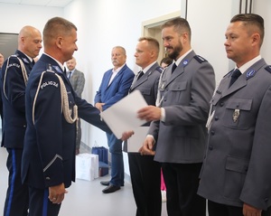 Pierwszy zastepca komendata Wojewódzkiego w bydgoszczy wręcza akt mianowania awansownemu policjantowi