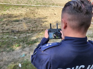 policjant steruje dronem