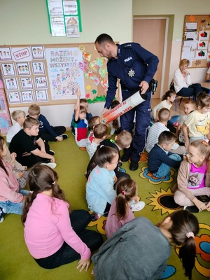 policjant chodzi wśród dzieci i prezentuje im tube